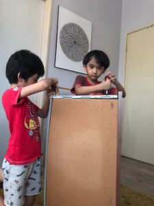 kids helping dismantle old wardrobe